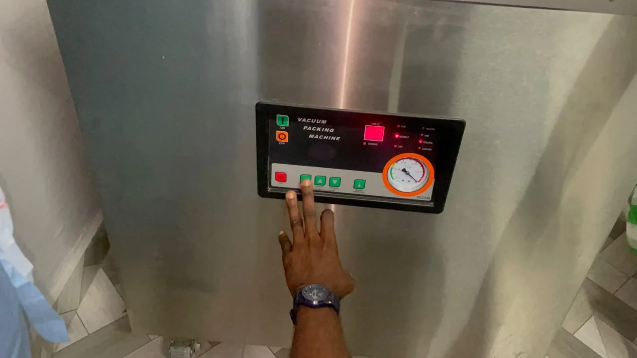 A team member operating processing equipment controls