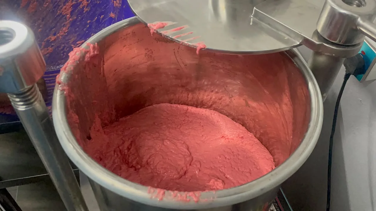 Food product being prepared in a stainless-steel bowl